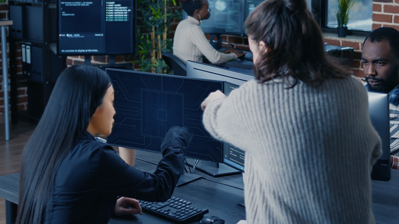 Illustrative view of engineers reviewing circuit board design data on a screen